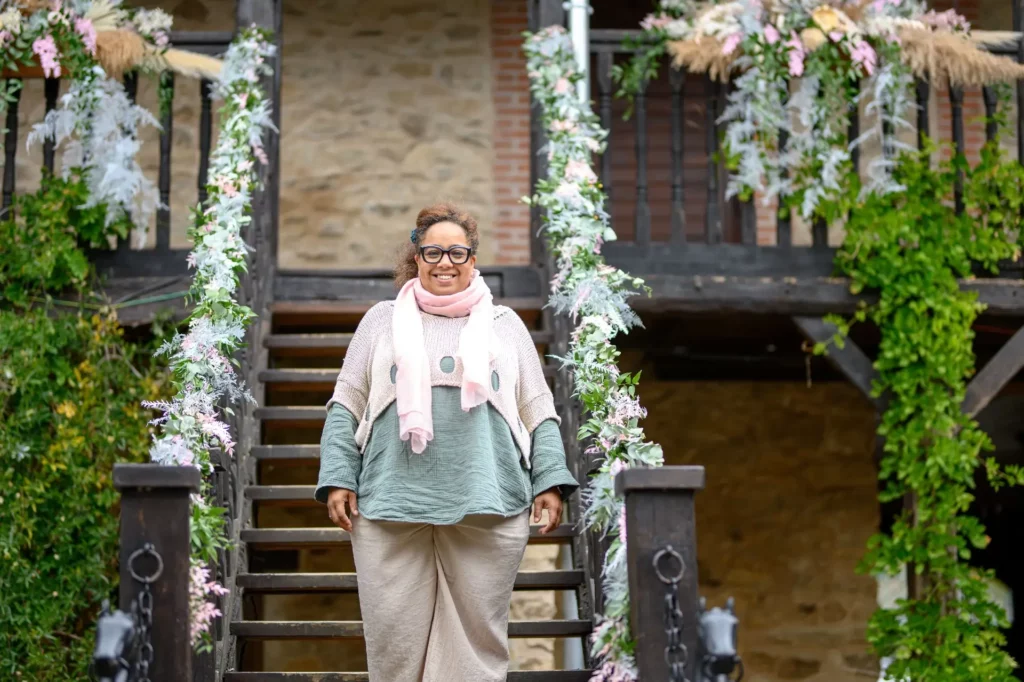 Peggy Ferry descendant un escalier décoré lors d’un mariage, symbolisant son accompagnement sur mesure